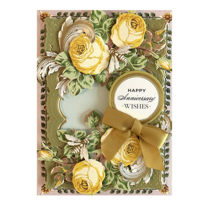a card with yellow roses and a ribbon.