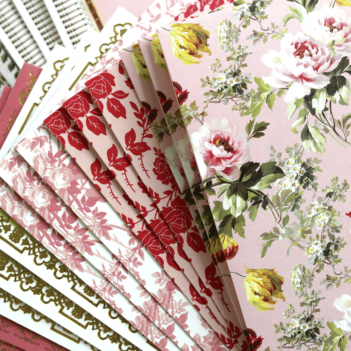 a close up of a bunch of papers with flowers on them.