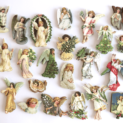 a collection of angel figurines on a white surface.