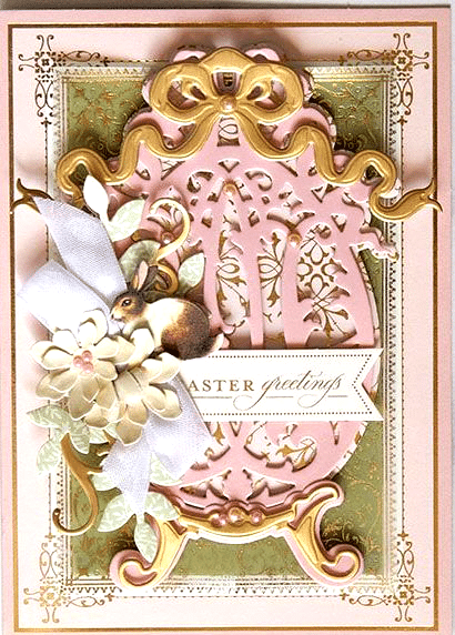 a pink and gold greeting card with flowers.